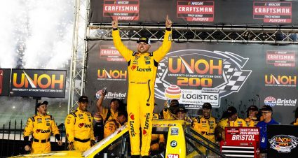 Layne Riggs points to the sky and celebrates in Victory Lane at Bristol Motor Speedway.