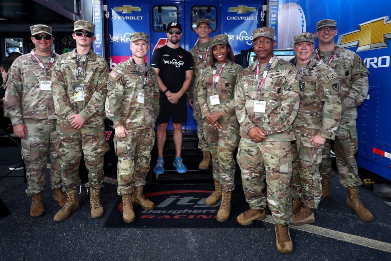 Ricky Stenhouse Jr. poses for a photo with U.S. military service members.