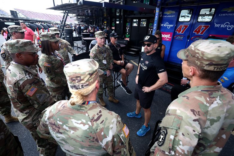Ricky Stenhouse Jr. speaks with U.S. military members.