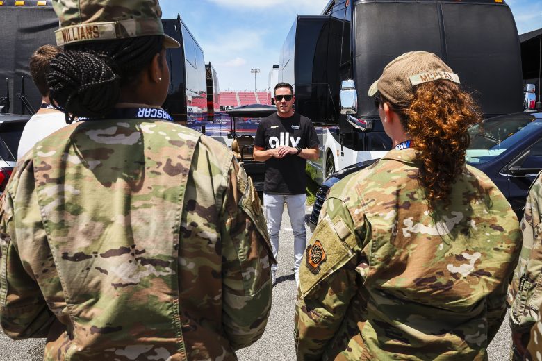 Alex Bowman speaks with U.S. military service members.