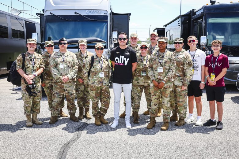 Alex Bowman poses for a photo with U.S. military service members.