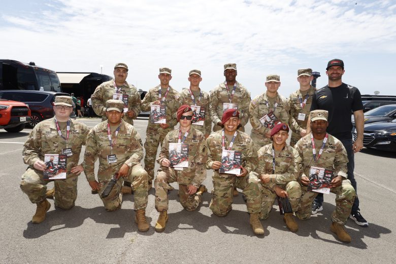 Corey LaJoie poses for a photo with U.S. military service members.