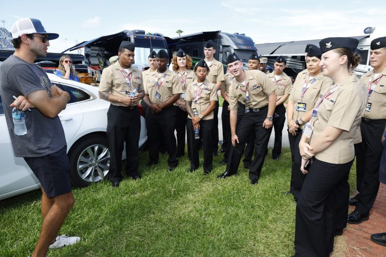 Chase Elliott speaks with U.S. military service members.