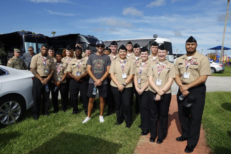 Chase Elliott poses for a photo with U.S. military service members.