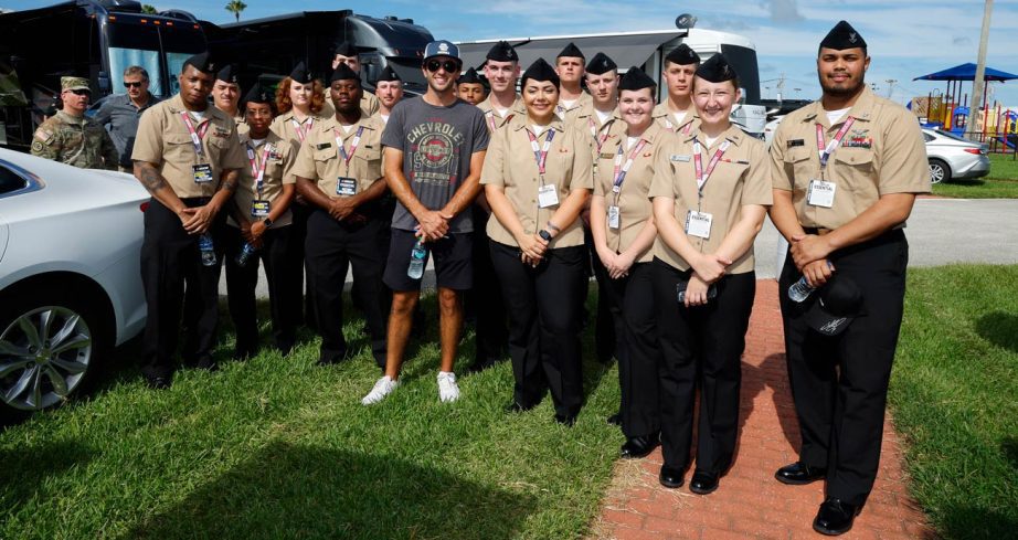 Chase Elliott poses for a photo with U.S. military service members.