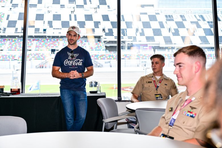 Daniel Suárez and U.S. military service members listen intently.