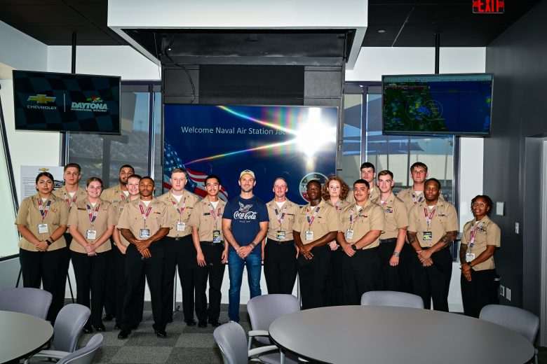 Daniel Suárez poses for a photo with U.S. military service members.