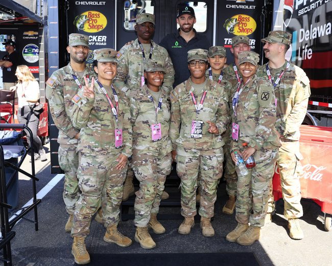 Austin Dillon poses for a photo with U.S. military service members.