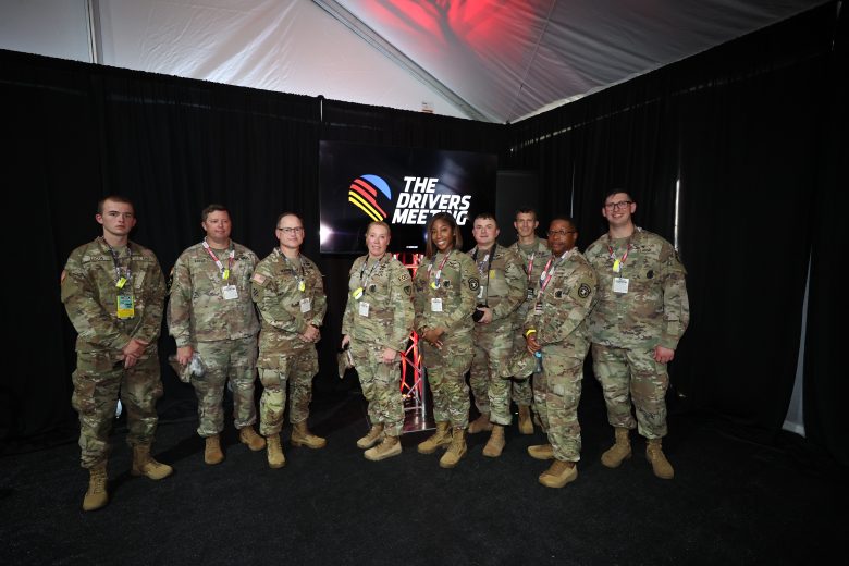 U.S. military service members pose for a photo at Darlington Raceway.