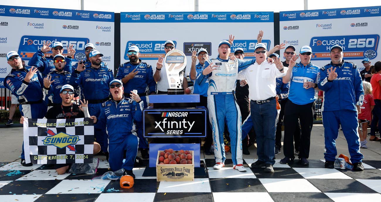 Austin Hill and his No. 21 Richard Childress Racing team pose for a photo following a NASCAR Xfinity Series win at Atlanta Motor Speedway.