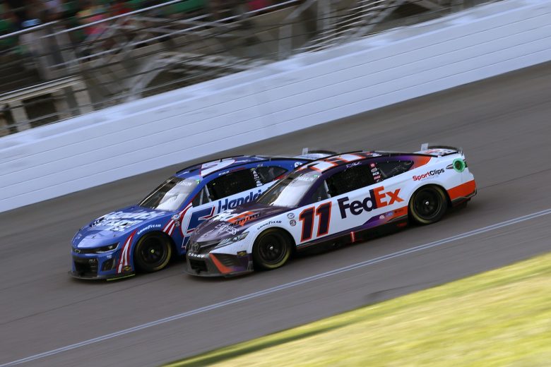 Larson races against Denny Hamlin at Kansas.