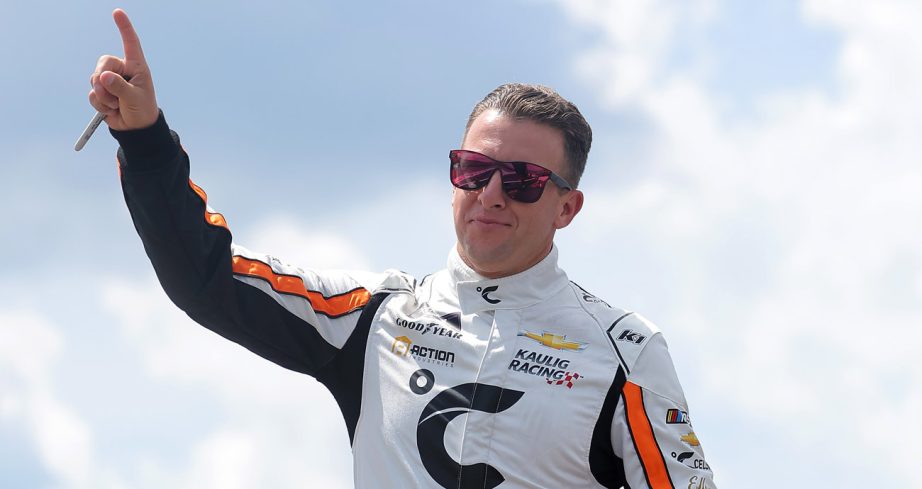 AJ Allmendinger points skyward during NASCAR driver introductions.