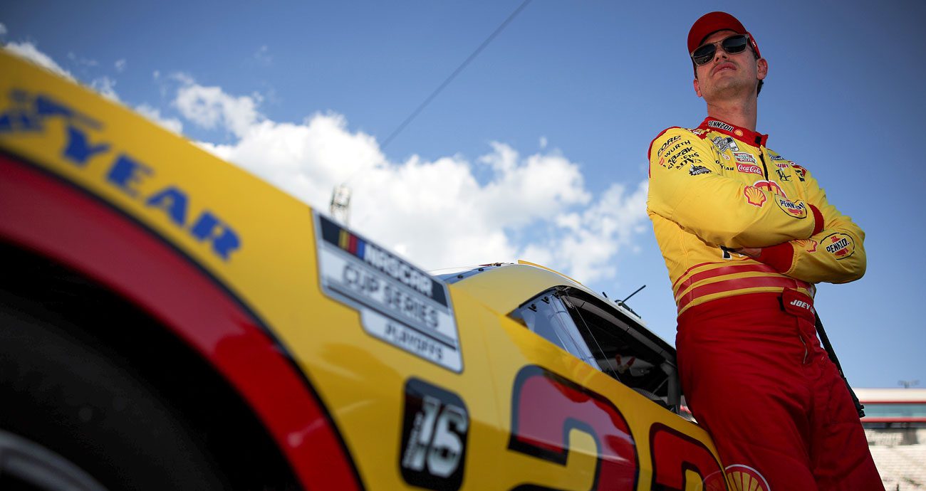 Joey Logano waits outside his car at Bristol.