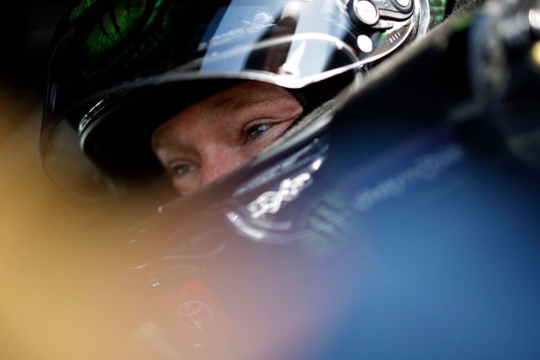 Tyler Reddick looks on while wearing helmet.