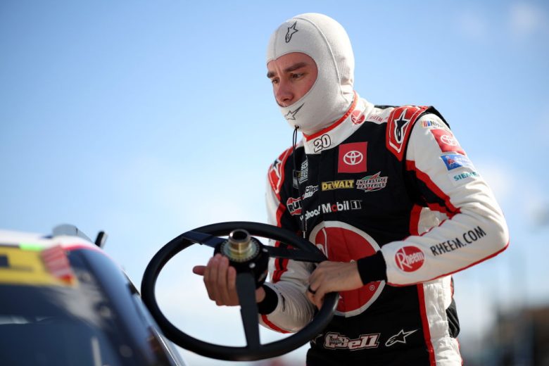 Christopher Bell holds his steering wheel.