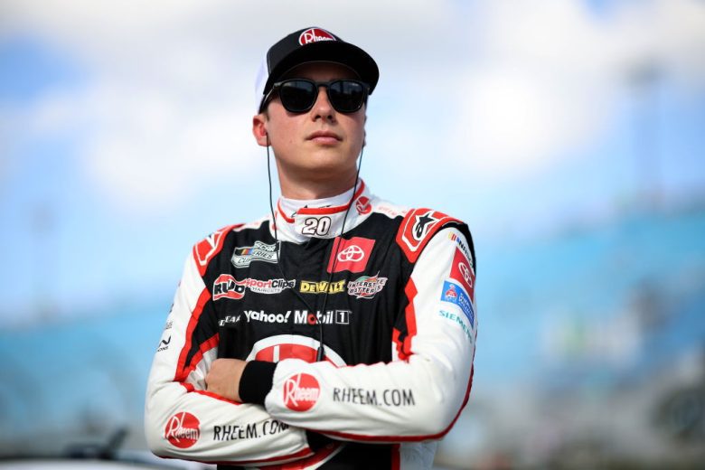 Christopher Bell looks on.