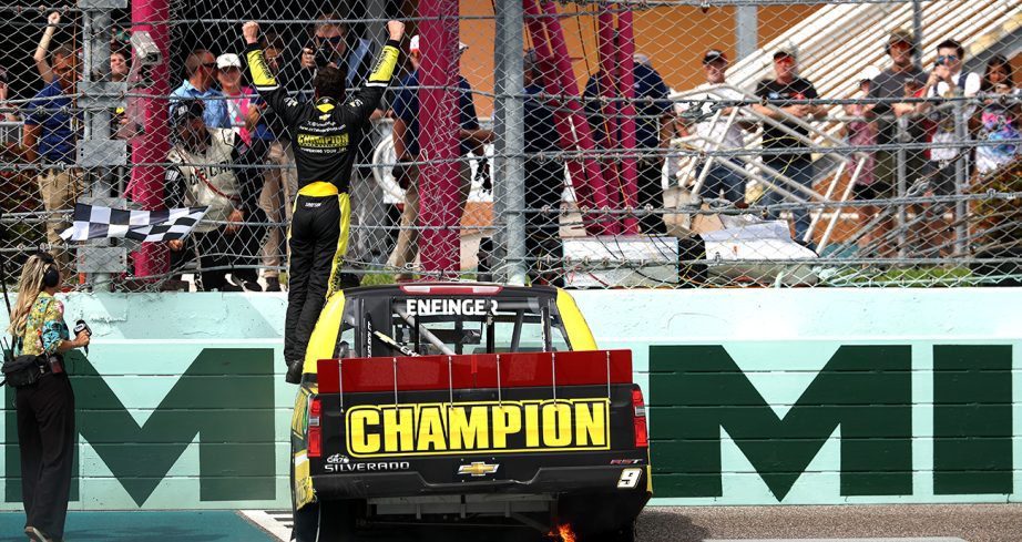 Grant Enfinger stands on top his No. 9 Chevrolet and raises his arms in celebration to the crowd.