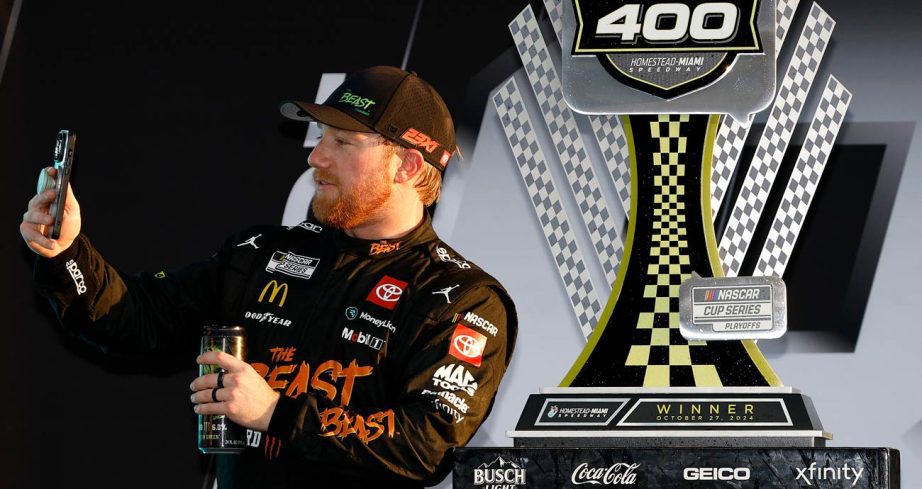 Tyler Reddick takes a selfie with the winner's trophy in Victory Lane at Homestead-Miami Speedway.