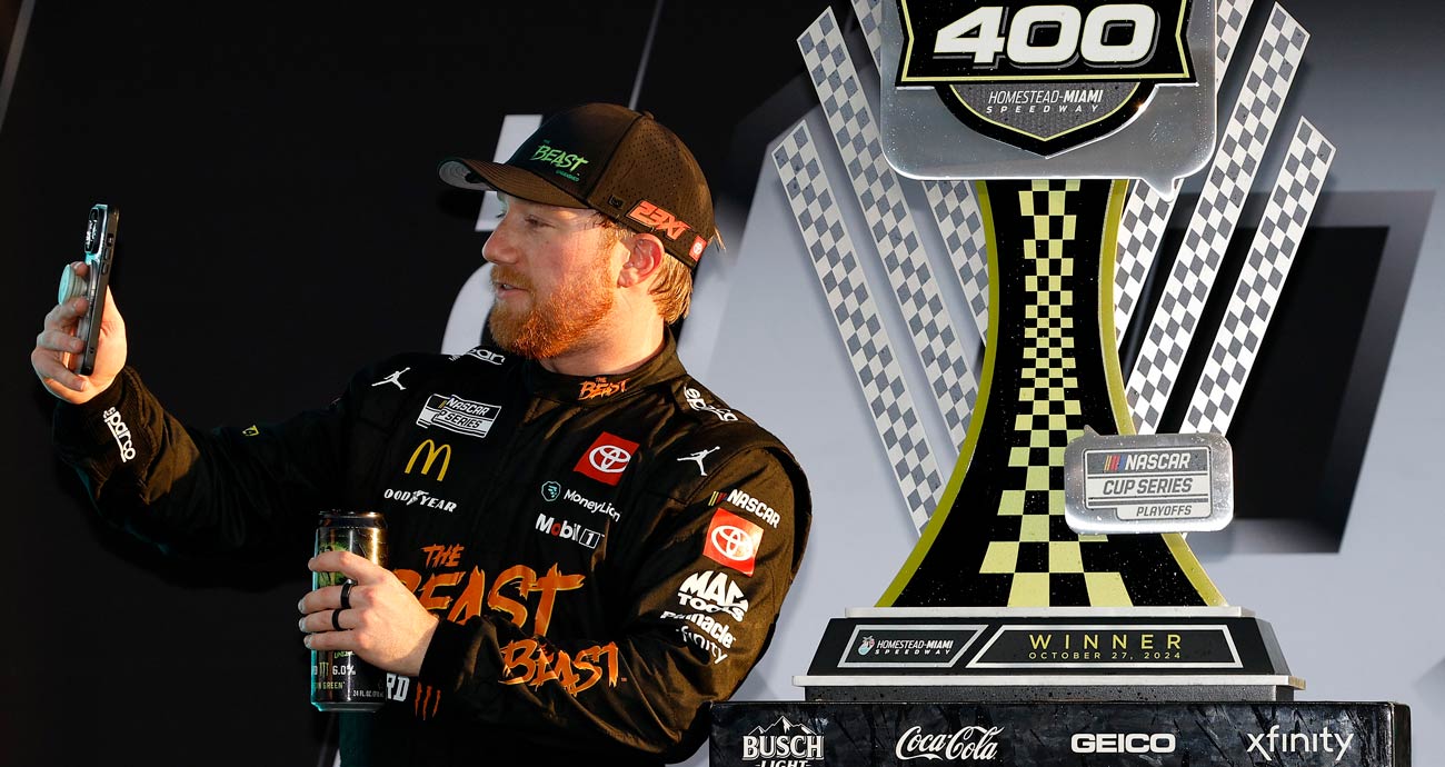 Tyler Reddick takes a selfie with the winner's trophy in Victory Lane at Homestead-Miami Speedway.
