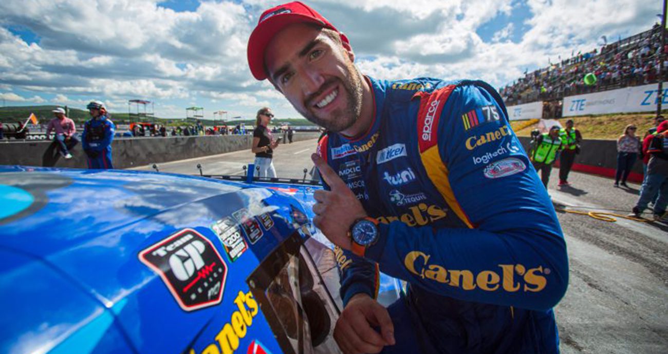 Rueben Garcia Jr. places winner sticker on car.