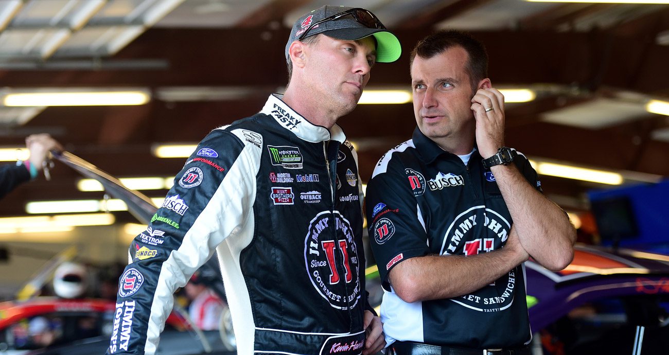 Kevin Harvick and Rodney Childers speak in the garage.