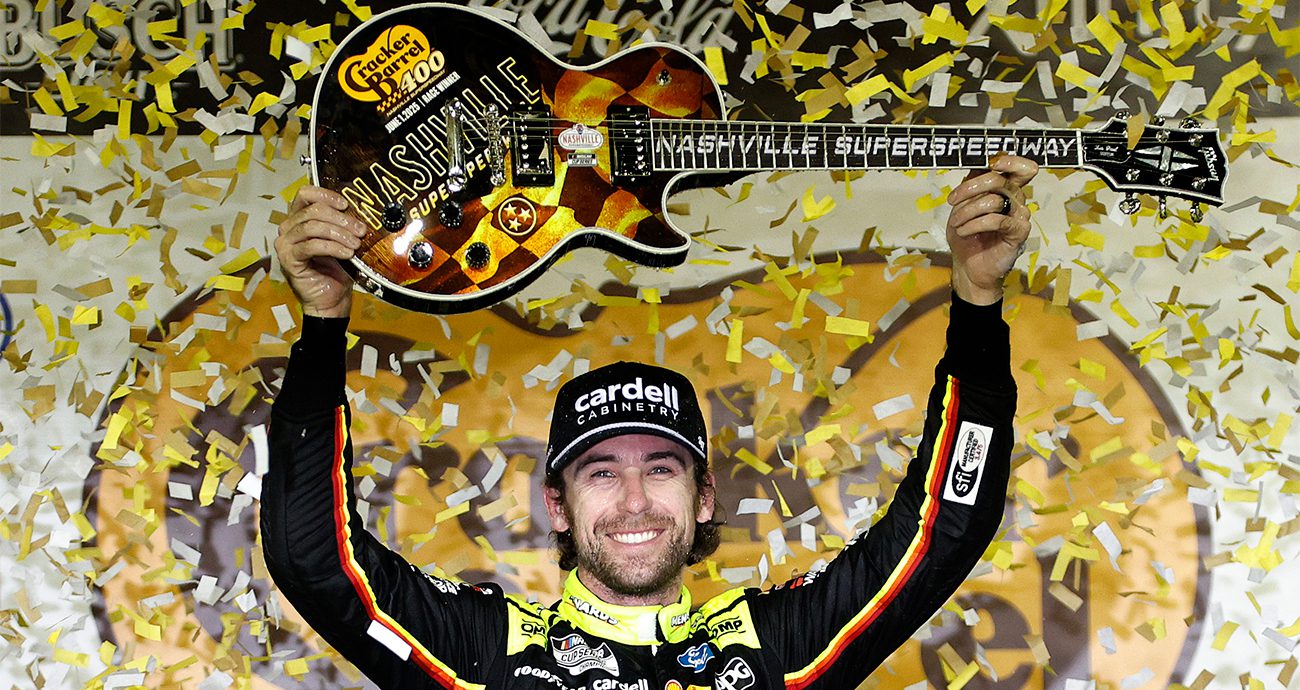 Ryan Blaney hoists a guitar in Victory Lane following his NASCAR Cup Series win at Nashville Superspeedway.