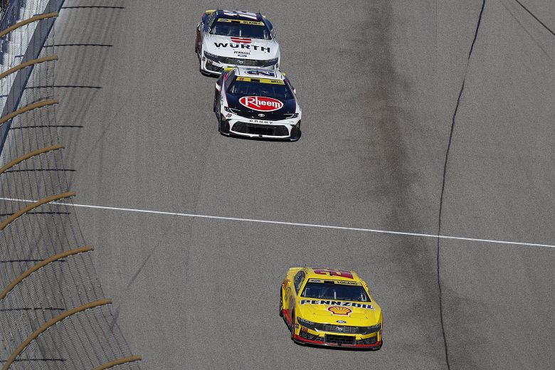 Joey Logano leads Christopher Bell and Ryan Blaney on track.