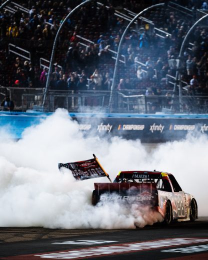majeski performs a burnout with champ flag