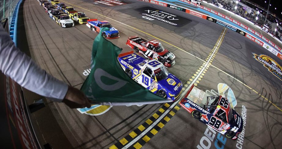 NASCAR Craftsman Truck Series trucks race to the green flag at Phoenix Raceway.