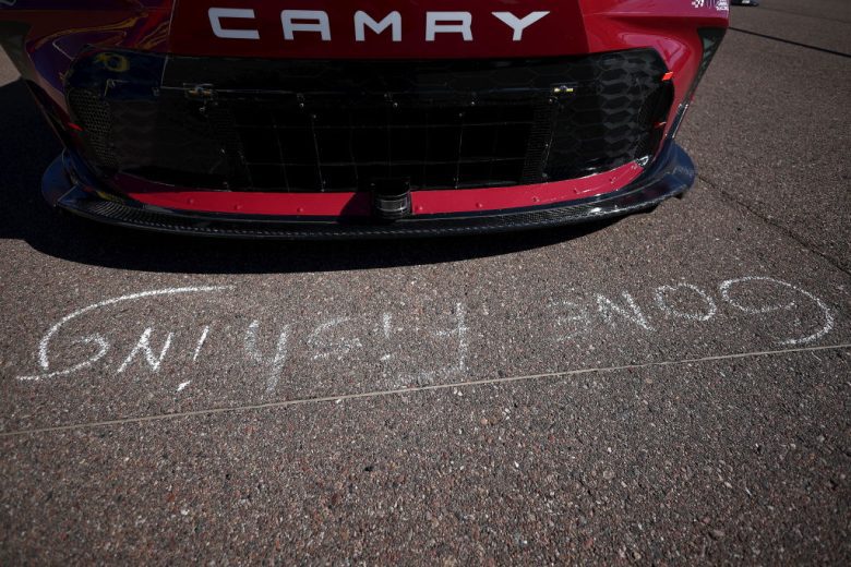 A general view of chalk words in front of Martin Truex Jr.'s No. 19 Joe Gibbs Racing Toyota.