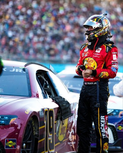 Martin Truex Jr. stands next to his No. 19 Toyota following the conclusion of the NASCAR Cup Series Championship at Phoenix Raceway.