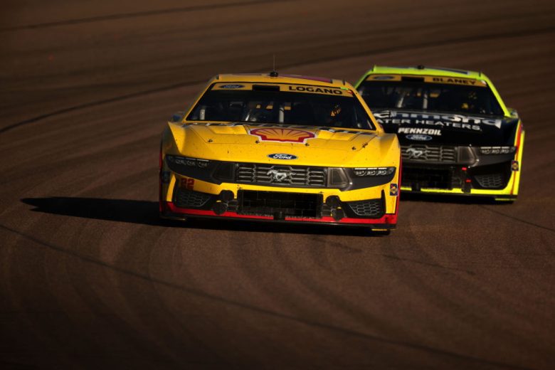 Joey Logano's No. 22 Team Penske Ford races ahead of Ryan Blaney's No. 12 Team Penske Ford at Phoenix Raceway.