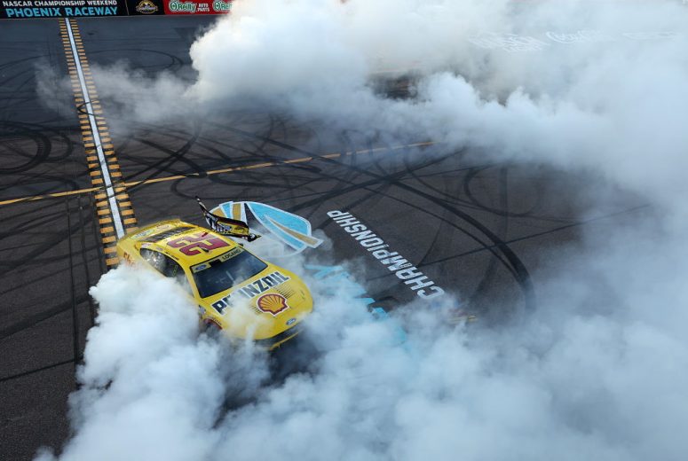 Joey Logano's No. 22 Team Penske Ford does a celebratory burnout at Phoenix Raceway.