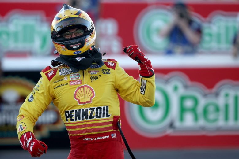 Joey Logano pumps his fists.