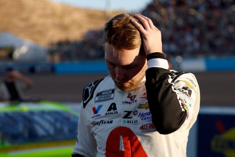 William Byron stands by and puts his arm over his head at Phoenix Raceway.