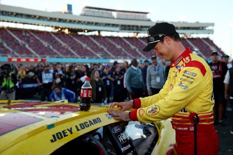 Joey Logano places the winner sticker on his No. 22 Team Penske Ford.