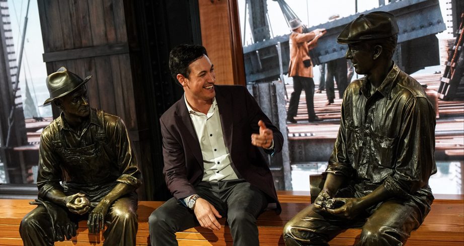 Joey Logano talks with statues at the Empire State museum.