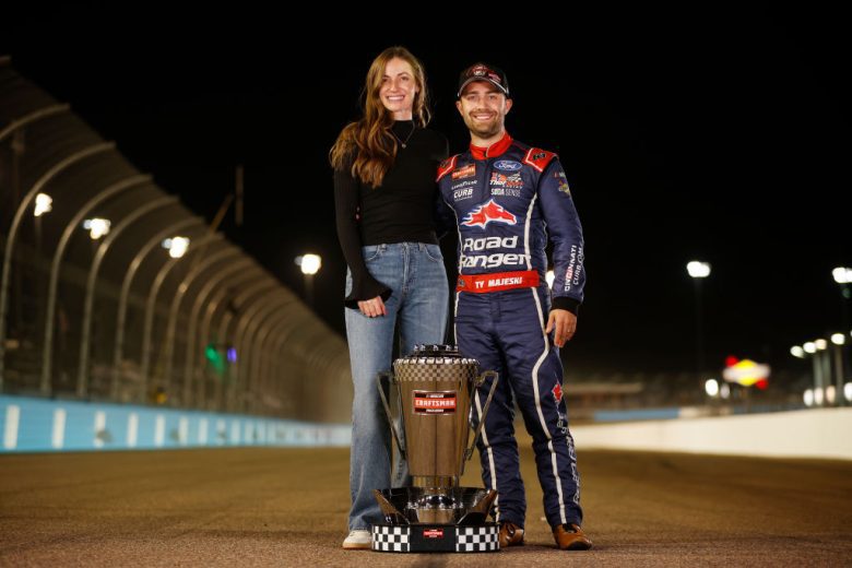 Ty Majeski and his wife pose with the championship trophy.