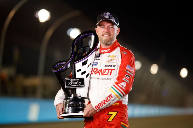 Justin Allgaier poses with the championship trophy.