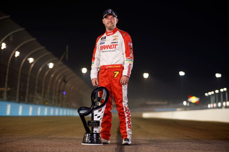 Justin Allgaier poses with the championship trophy.