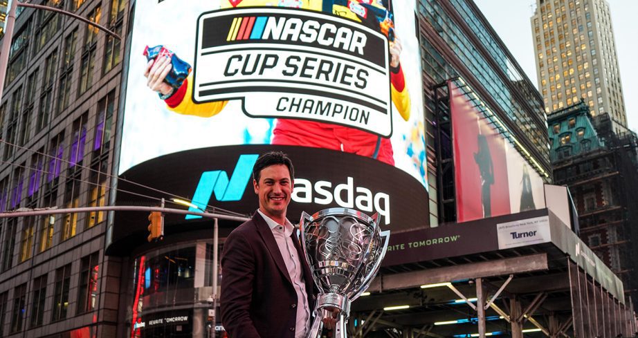 Joey Logano holds up the Bill France Cup in New York City.