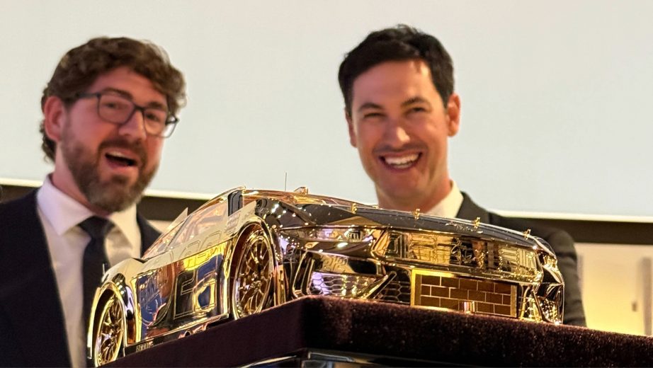 Joey Logano looks at the Goodyear gold car.