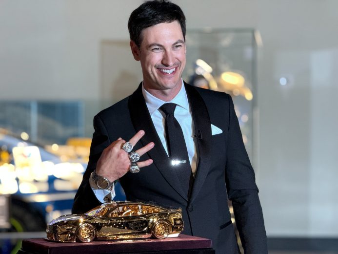 Joey Logano poses with the Goodyear gold car.