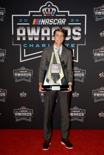 Carson Hocevar poses with the Rookie of The Year trophy.