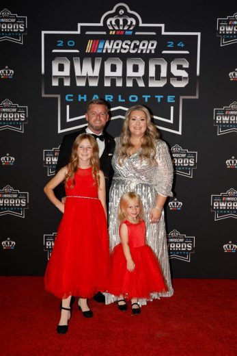 Justin Allgaier and his family pose on the red carpet.
