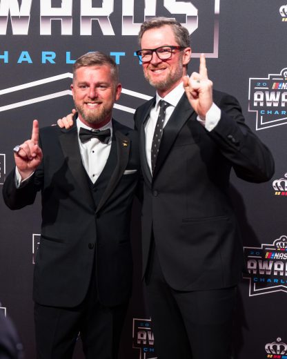 Dale Jr. and Justin Allgaier pose for pictures on red carpet.