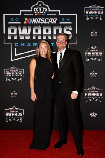 Amy Earnhardt (L) and Dale Earnhardt Jr. pose for a photo on the red carpet.