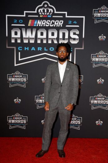 Rajah Caruth poses for a photo on the red carpet.