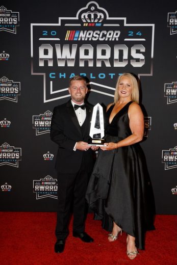 Justin Allgaier (L) poses for a photo on the red carpet.