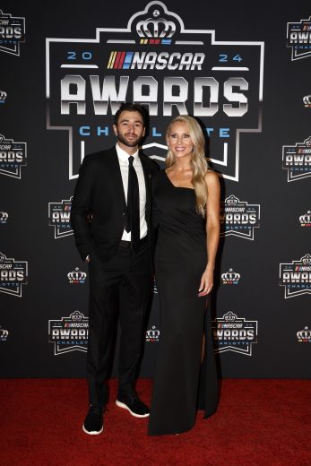 NASCAR Cup Series driver Chase Elliott (L) poses for a photo on the red carpet.